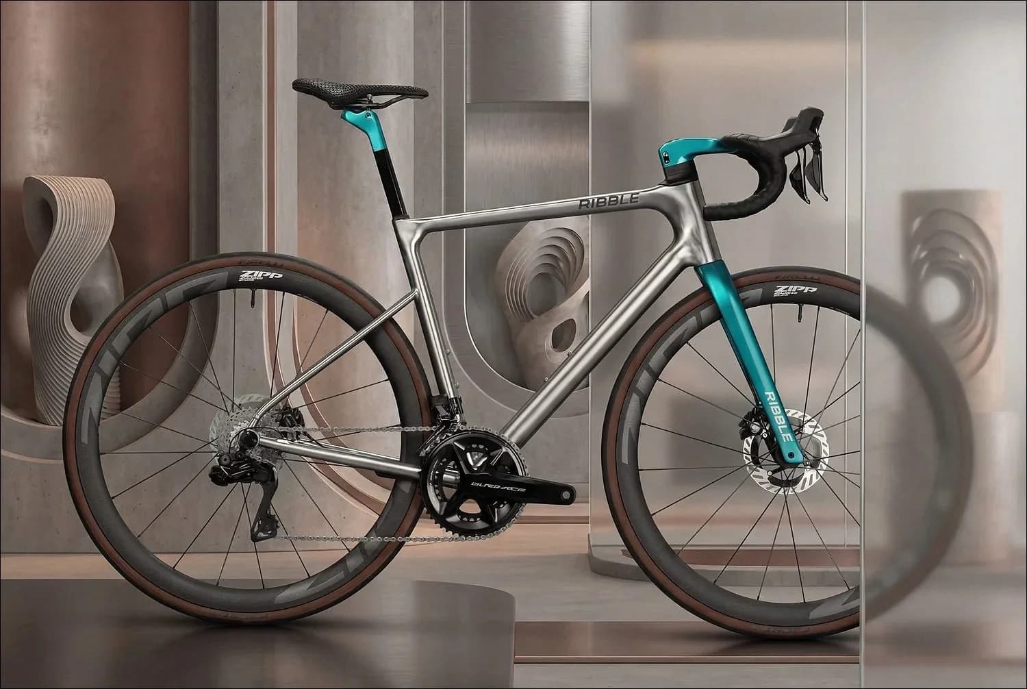 Side profile of a polished titanium Ribble road bike with a teal CustomColour fork